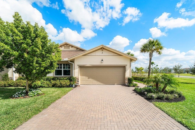 view of front of house with a garage and a front lawn