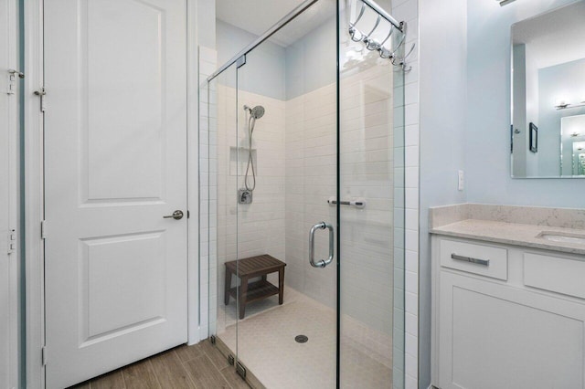 bathroom featuring vanity and a shower with shower door