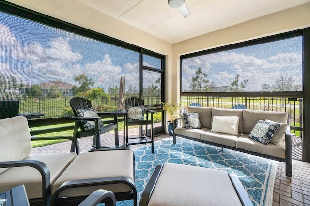 sunroom / solarium with plenty of natural light and ceiling fan