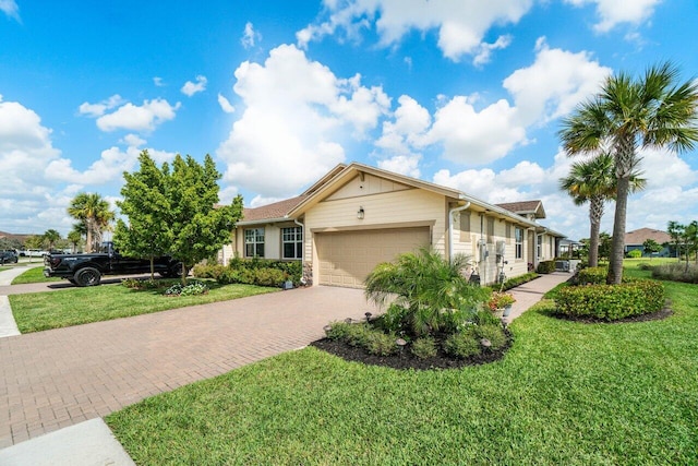 single story home featuring a garage and a front lawn