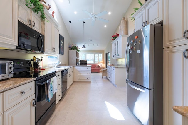 kitchen with light tile patterned floors, lofted ceiling, a sink, a peninsula, and black appliances