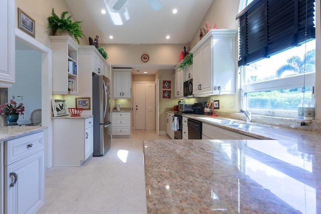 kitchen featuring open shelves, recessed lighting, a sink, light stone countertops, and black appliances