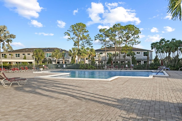 pool with fence and a patio