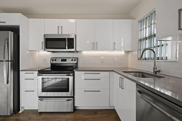 4640 Lucerne Lakes Blvd Unit 306, Lake Worth, FL 33467 - kitchen with stainless steel appliances, a sink, decorative backsplash, and white cabinets