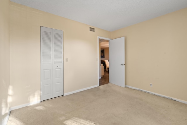 4640 Lucerne Lakes Blvd Unit 306, Lake Worth, FL 33467 - unfurnished bedroom featuring carpet flooring, a closet, and baseboards