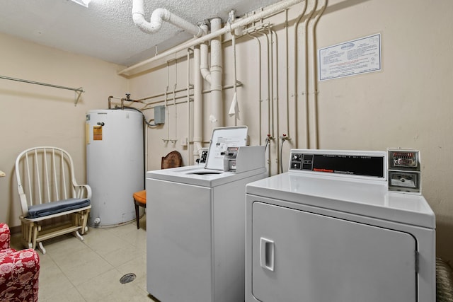 4640 Lucerne Lakes Blvd Unit 306, Lake Worth, FL 33467 - laundry area featuring water heater, washing machine and dryer, and a textured ceiling