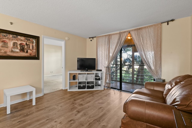 4640 Lucerne Lakes Blvd Unit 306, Lake Worth, FL 33467 - living area featuring a textured ceiling and wood finished floors