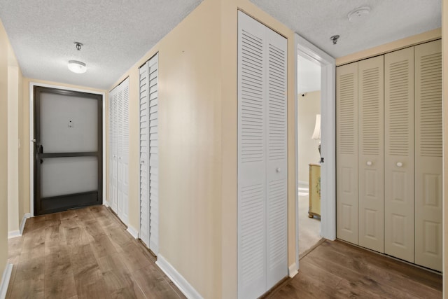 4640 Lucerne Lakes Blvd Unit 306, Lake Worth, FL 33467 - hall with wood finished floors, a textured ceiling, and baseboards