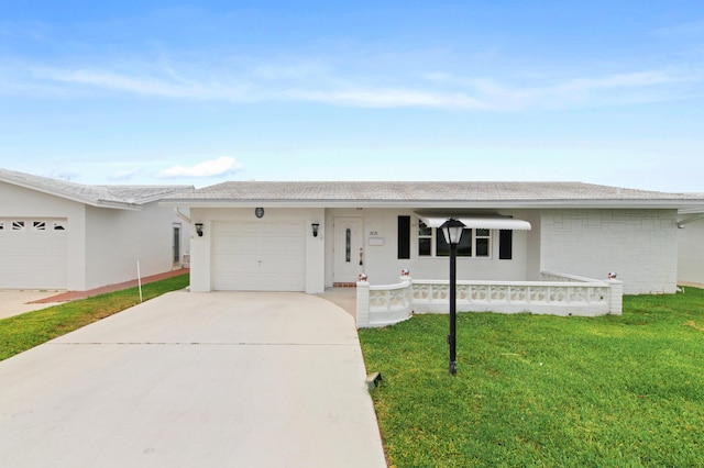 ranch-style home with a garage and a front yard