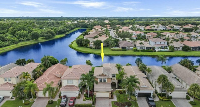 drone / aerial view featuring a residential view and a water view