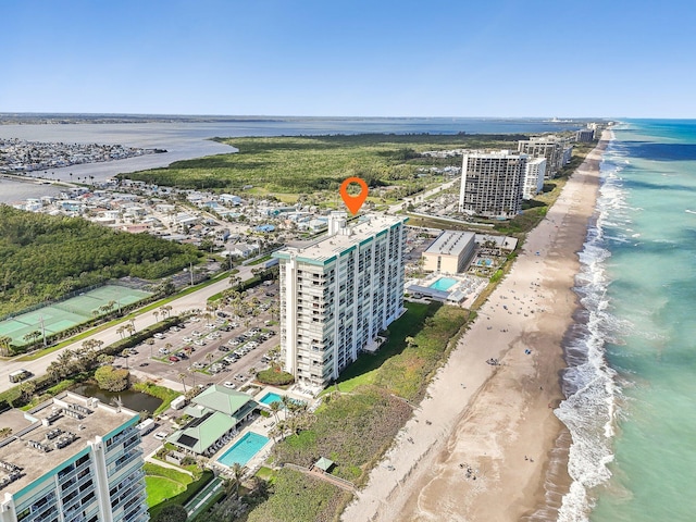 bird's eye view with a water view and a beach view