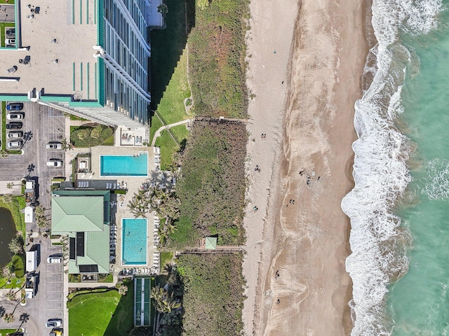 birds eye view of property featuring a water view and a view of the beach