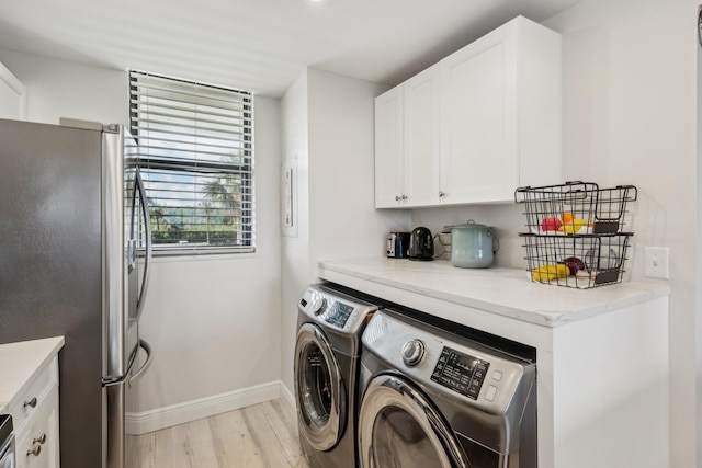 washroom featuring washer and dryer and light hardwood / wood-style floors