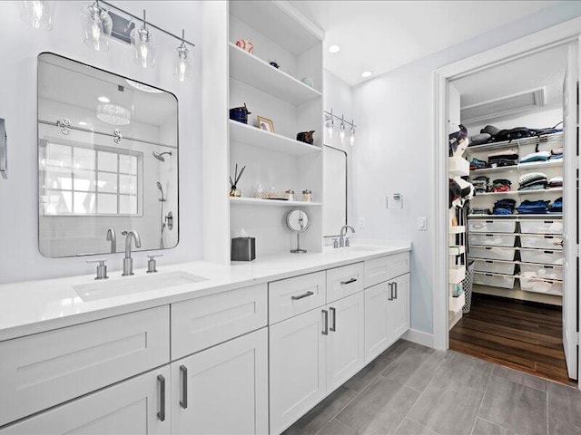 bathroom featuring walk in shower and vanity