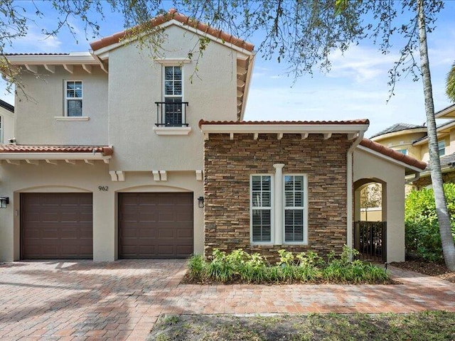 mediterranean / spanish house with a garage