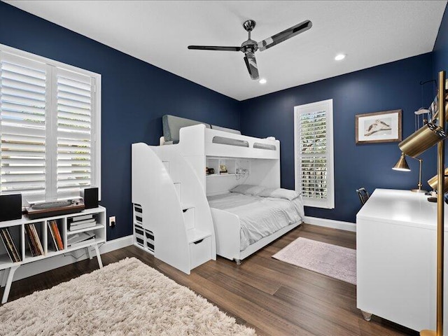 bedroom with ceiling fan and dark hardwood / wood-style flooring