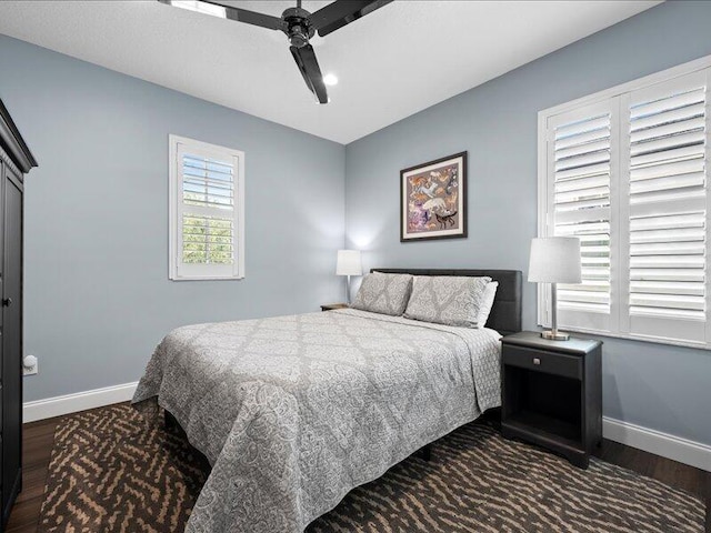 bedroom featuring ceiling fan and dark hardwood / wood-style flooring