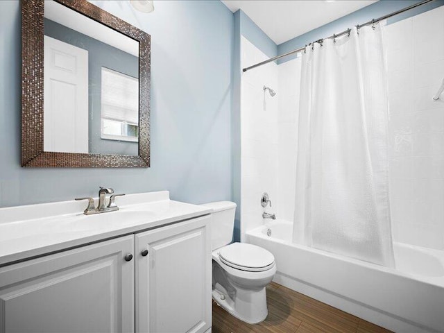 full bathroom featuring vanity, wood-type flooring, shower / bath combination with curtain, and toilet