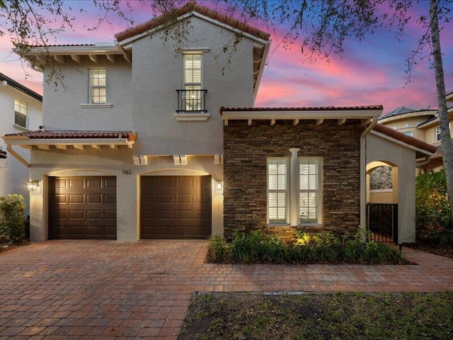 mediterranean / spanish house with a garage