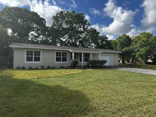 ranch-style house with central AC, a garage, and a front lawn