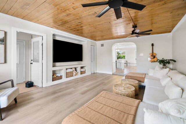 bedroom featuring ceiling fan, baseboards, crown molding, and wood finished floors