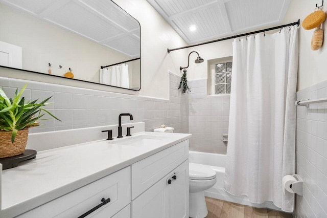 1630 N Ocean Breeze, Lake Worth Beach, FL 33460 - bathroom featuring tile walls, vanity, toilet, shower / bath combo with shower curtain, and wainscoting