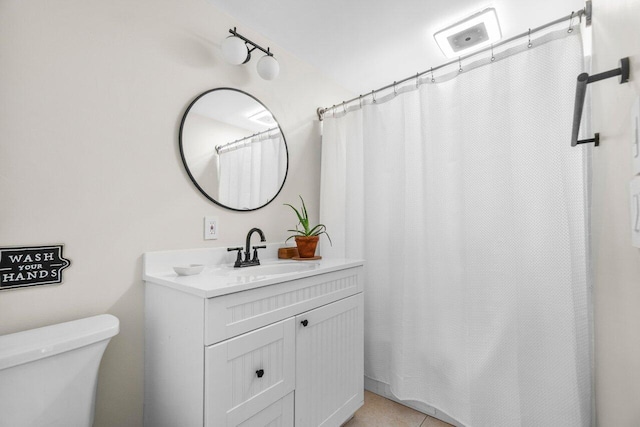 bathroom with toilet, vanity, and a shower with curtain