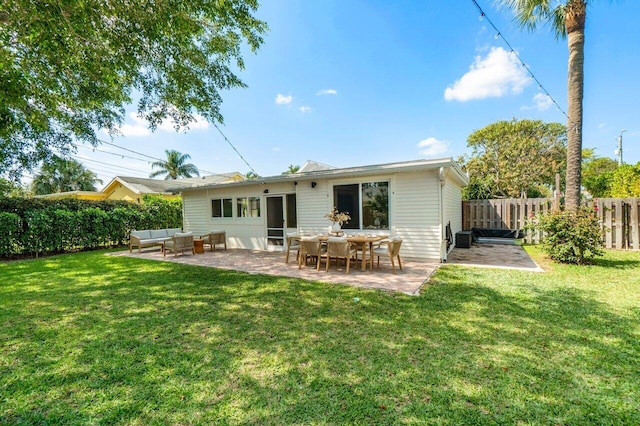 back of property featuring a yard, a patio area, outdoor lounge area, and fence