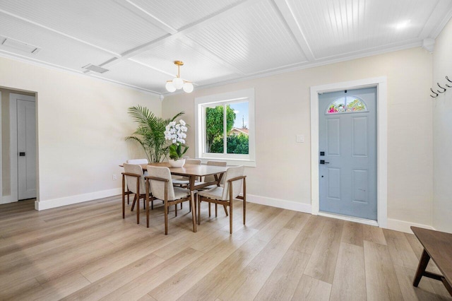 dining area with light wood-style floors, baseboards, coffered ceiling, and a chandelier