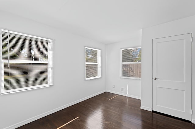 empty room featuring dark hardwood / wood-style flooring