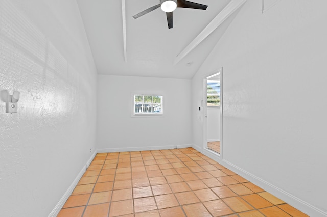 tiled empty room with vaulted ceiling and ceiling fan