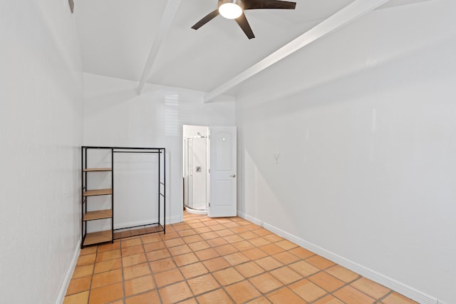 spare room featuring lofted ceiling with beams, light tile patterned floors, and ceiling fan