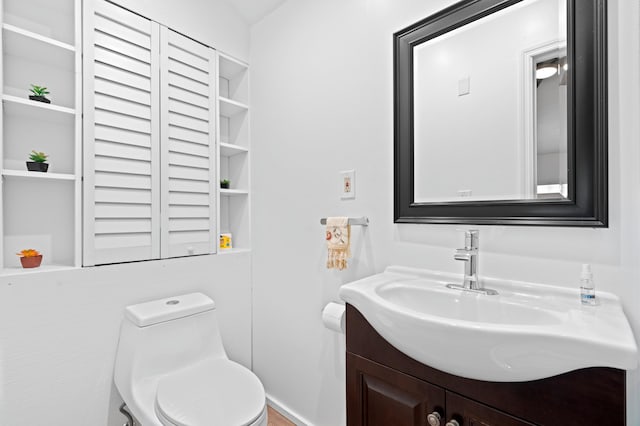 bathroom with vanity and toilet