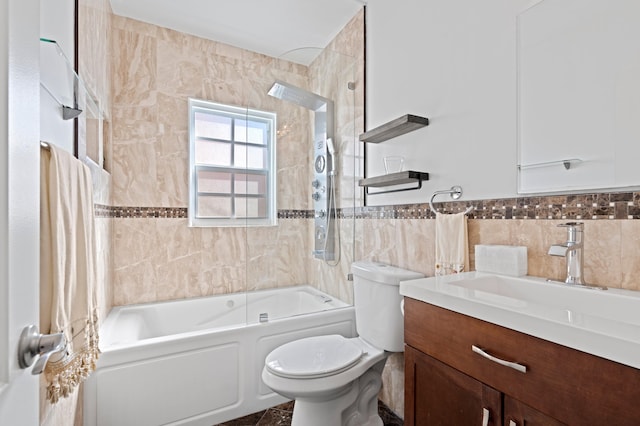 full bathroom with tiled shower / bath combo, vanity, tile walls, and toilet