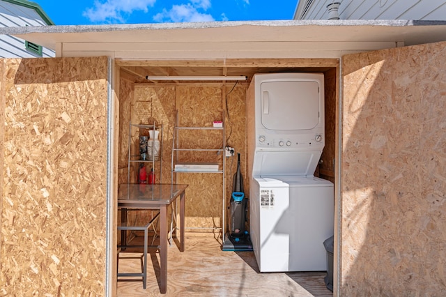 laundry area with stacked washing maching and dryer