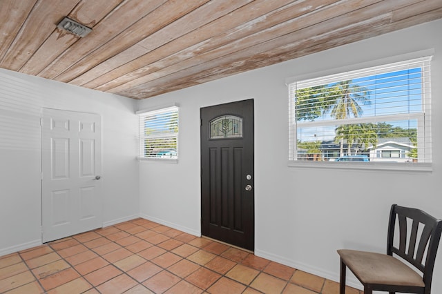 tiled entryway featuring wooden ceiling