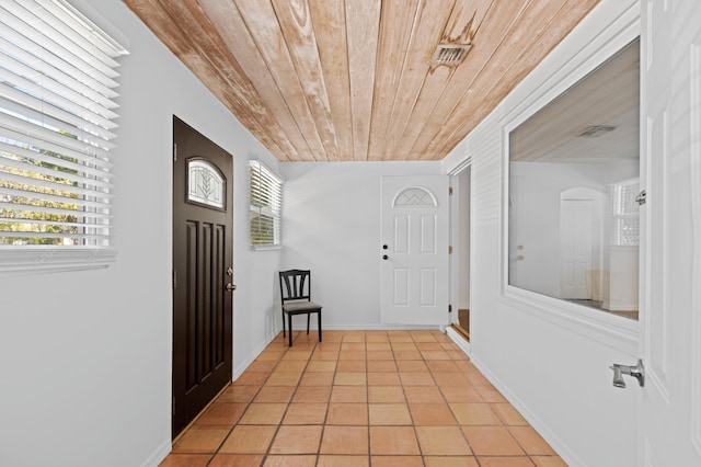 tiled foyer entrance featuring wood ceiling