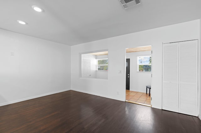 unfurnished room with wood-type flooring