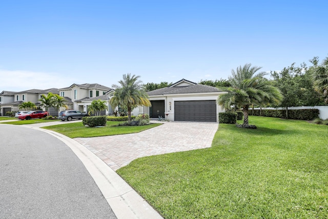 ranch-style home with a garage and a front lawn