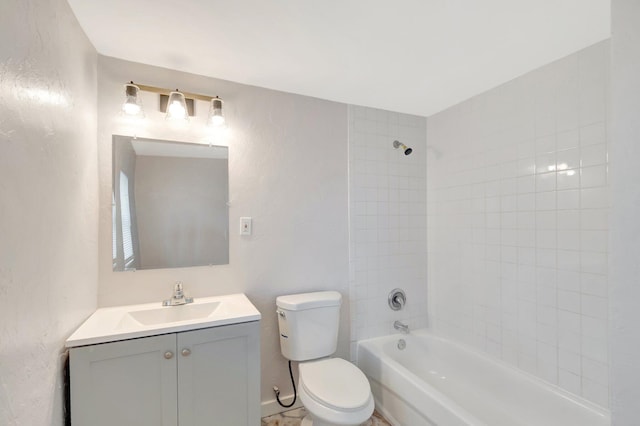 bathroom featuring a textured wall, vanity, toilet, and shower / bathtub combination