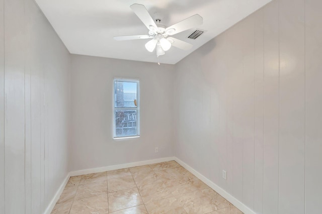 unfurnished room featuring visible vents, ceiling fan, and baseboards