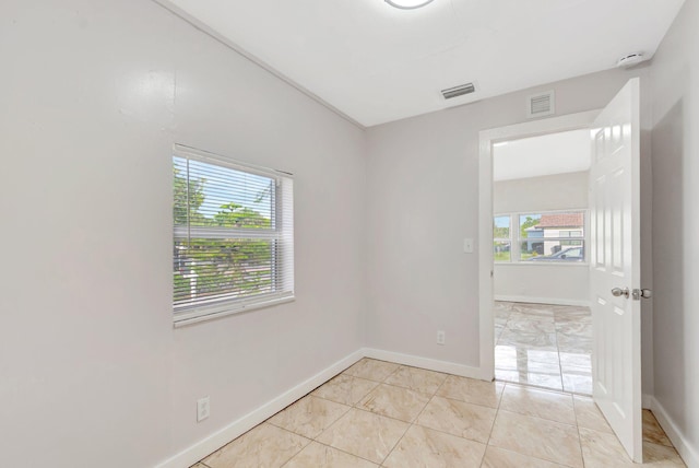 unfurnished room featuring visible vents, baseboards, and light tile patterned floors