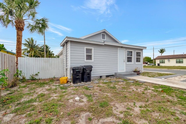 rear view of property featuring fence