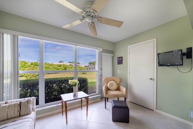 sunroom / solarium featuring a ceiling fan