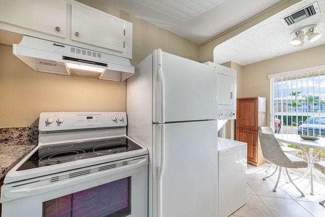 kitchen featuring white appliances, visible vents, under cabinet range hood, and white cabinetry