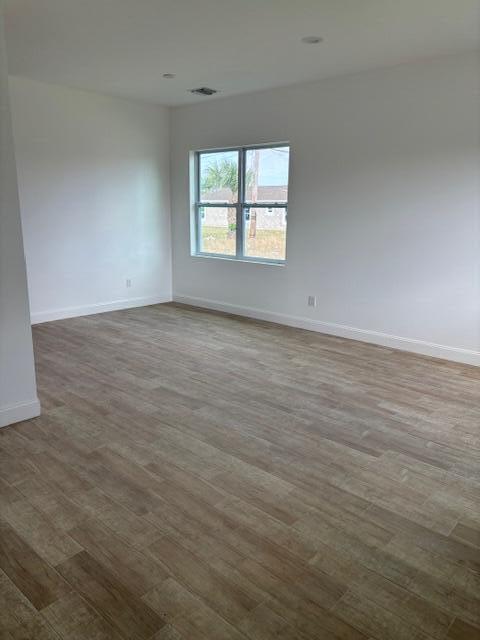 unfurnished room featuring wood-type flooring