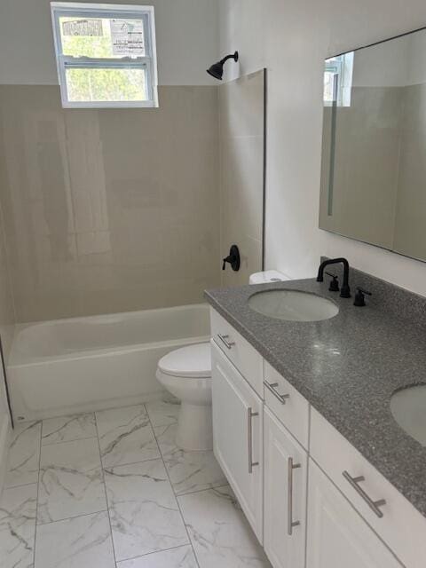 full bathroom featuring tiled shower / bath, vanity, and toilet