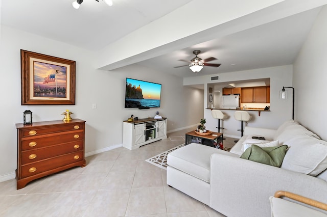 living room with ceiling fan and light tile patterned floors