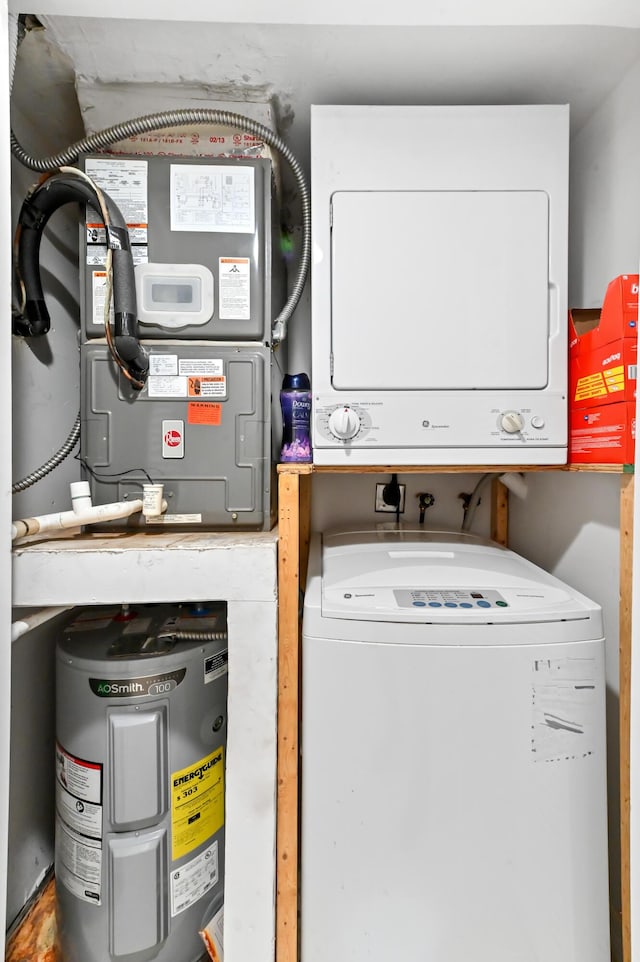 clothes washing area featuring stacked washing maching and dryer