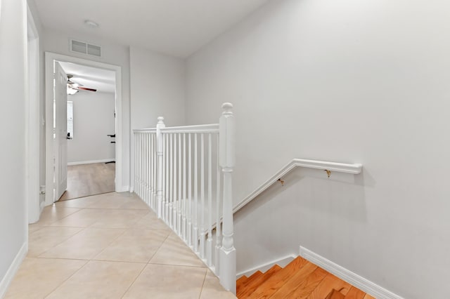 hall with light tile patterned floors